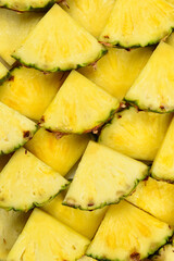 Pineapple juicy yellow slices background. Top view.