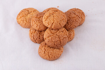 Pyramid pile of delicious almond cookie biscuits on white