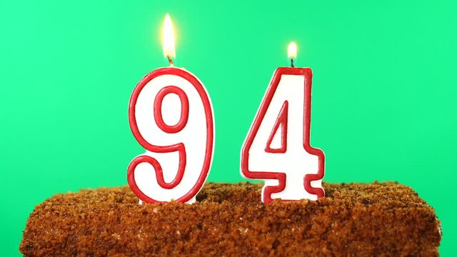 Cake with the number 94 lighted candle. Chroma key. Green Screen. Isolated