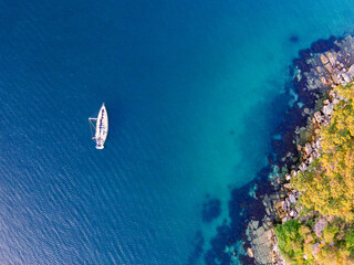 Aerial drone bird's eye view of one sailboat yacht anchored at Store Beach near Quarantine Station...