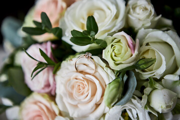 wedding rings lie on the wedding bouquet