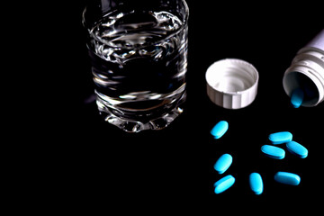 
Tablets with a glass of water and packaging