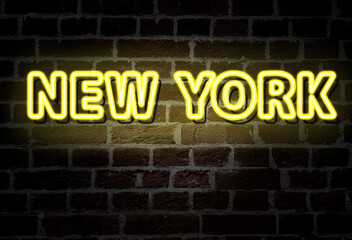 New York City - yellow neon sign on brick wall