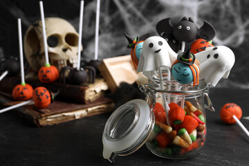 Different Halloween themed cake pops on black table