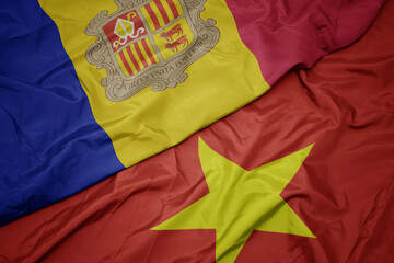 waving colorful flag of vietnam and national flag of andorra.