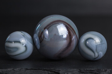 group of opaque glass marbles in grey with white and black swirls