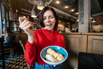 Young woman having fun and eating ice cream in coffee
