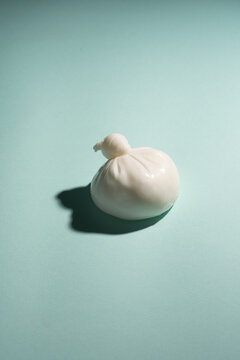 burata italian fresh cheese from buffalo milk white on blue background