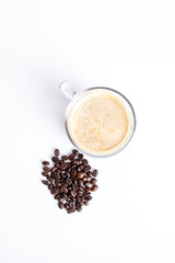 A glass of coffee top view and coffee beans on white background