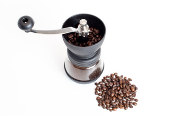 coffee grinder with coffee beans on white background