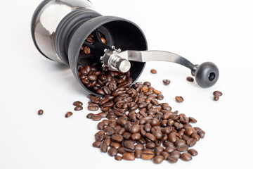coffee grinder with coffee beans on white background