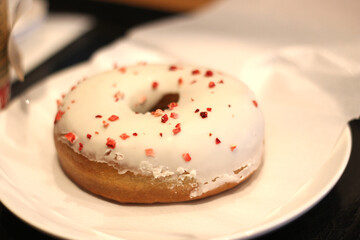 Close up of a delicious strawberry white chocolate donut (doughnut) on a paper, soft focus, Kyoto, Japan