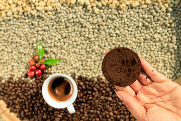 coffee grounds and coffee cup and red with green leaves and dried coffee beans processed backgrounds top view shot