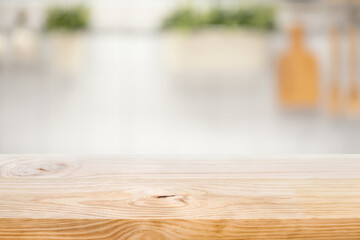 Wood table top on blur kitchen counter (room)background