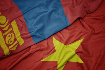 waving colorful flag of vietnam and national flag of mongolia.