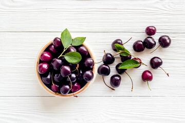 Sweet red cherries with leaves, flat lay, top view
