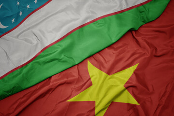 waving colorful flag of vietnam and national flag of uzbekistan.