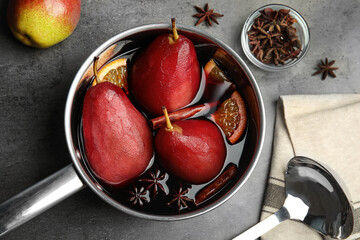 Fototapeta na wymiar Poaching pears in mulled wine on grey table, flat lay