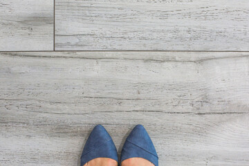 Women Female Feet Shoes at inside facility grey tiles space for Social Distancing sign