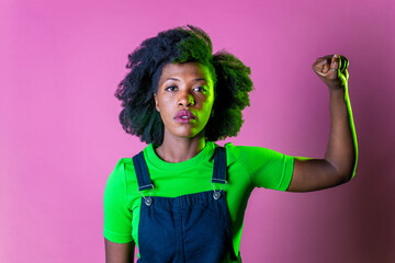 Confident black woman protesting against racial discrimination isolated on pink background - Young...