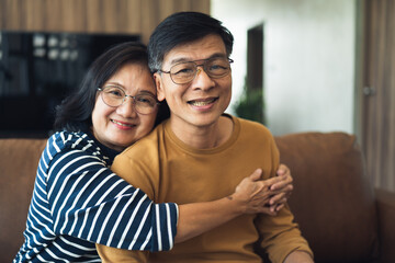 portrait of a smiling couple give warm hug in front of a camera.