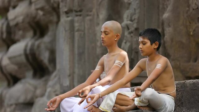 Young indian child  doing yoga in the park