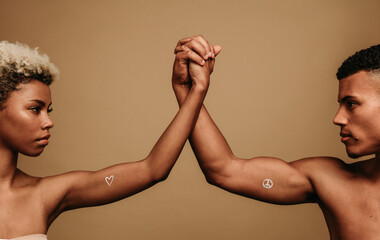 Man and woman holding hands symbolising unity