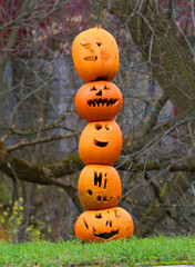 Single stack of pumpkin jack-o-lanterns on a pole