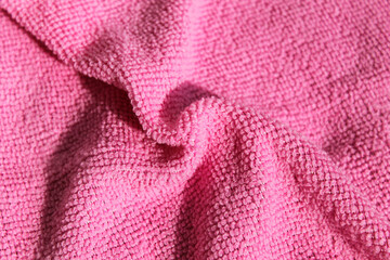Fototapeta na wymiar Pink microfiber napkin. Red cloth for the kitchen.