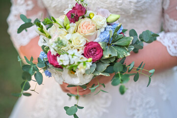 Bride holds a wedding bouquet, wedding dress, wedding details