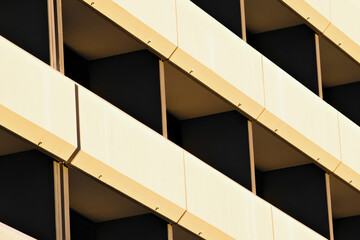 Architectural fragment of modern minimalist building facade, balconies with white metal cladding