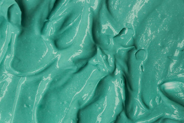 Green natural cosmetic face mud, textured background. Green clay face mask, close up