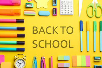 Text Back To School and different stationery on yellow background, flat lay