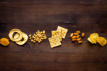 Fototapeta premium Flat lay of appetizers and snacks overhead. Nuts and dried fruits with crackers