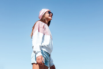 Girl with breast cancer, wearing a pink head scarf on October 19, International Breast Cancer Day