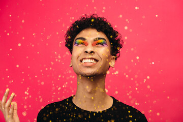 Transgender man playing with glitter