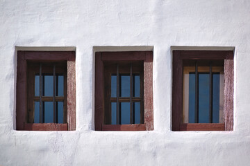 Three old vintage windows on white wall 