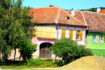 Fototapeta na wymiar Typical rural landscape and peasant houses in the village Cincsor, Kleinschenk, Transylvania, Romania. The settlement was founded by the Saxon colonists in the middle of the 12th century