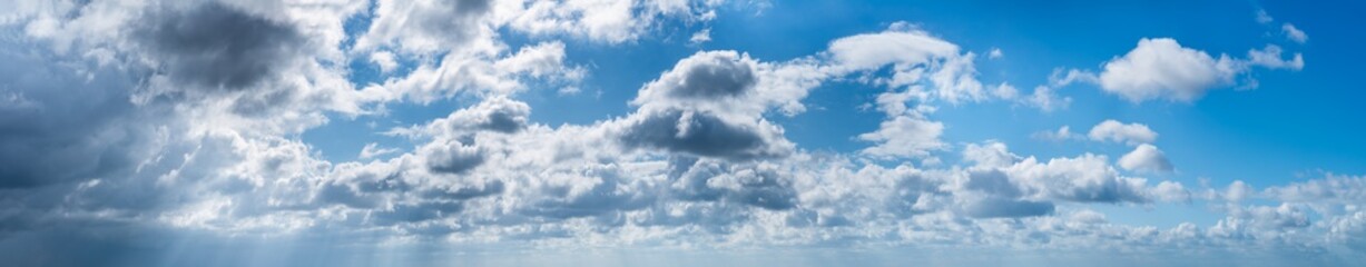 Fantastic clouds against blue sky, panorama