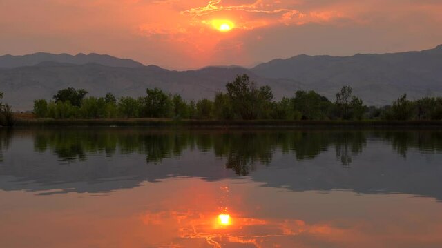 Reflection of sunset over lake surface during wildfires of late August 2020 in Colorado