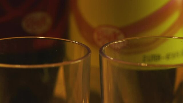 Pan Across Two Drinking Glasses and Cereal Box, Close Up in Dark Room