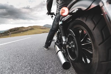 Foto op Plexiglas Driver riding motorcycle on an asphalt road in mountain © Jag_cz