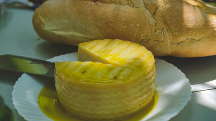 A loaf of bread and delicious cheese to eat.