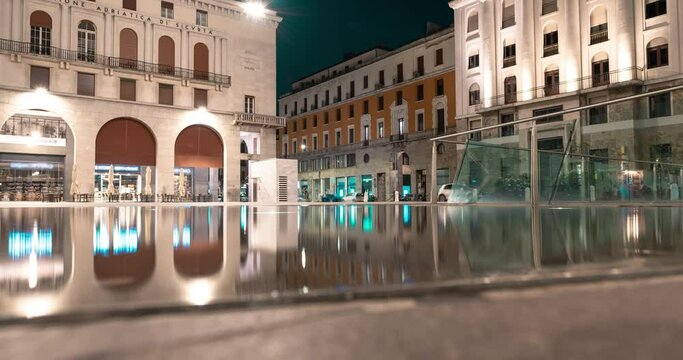 Movement of the moon in a night square. Victory Square, Brescia, Italy. Video 4K Time Lapse.
