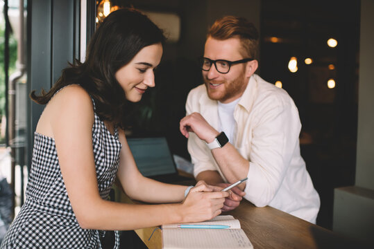 Young hipster couple talking in cafeteria