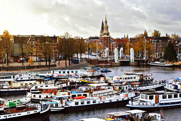 Ships on the canals in Amsterdam, cloudy sky in November