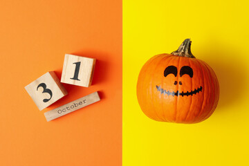 Pumpkin and wooden calendar with 31 october on two tone background