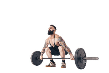 Fototapeta na wymiar The technique of doing an exercise of deadlift with a barbell of a muscular strong tattooed bearded sports men on a white studio background. Isolate.