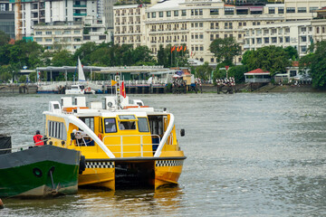 Saigon water-bus on the Saigon river and center of Ho Chi Minh city in background