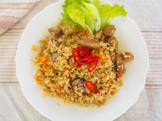 plate with pilaf, hot pepper and herbs. national cuisine. Oriental food.